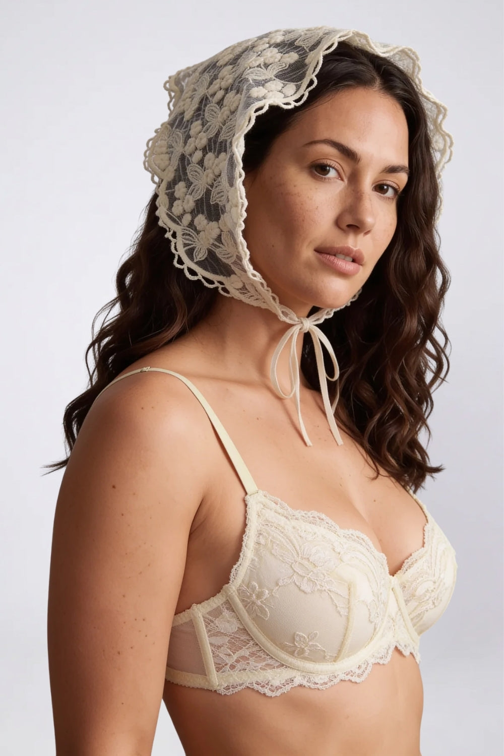 Model wearing floral cotton lace tie-front headwear in white