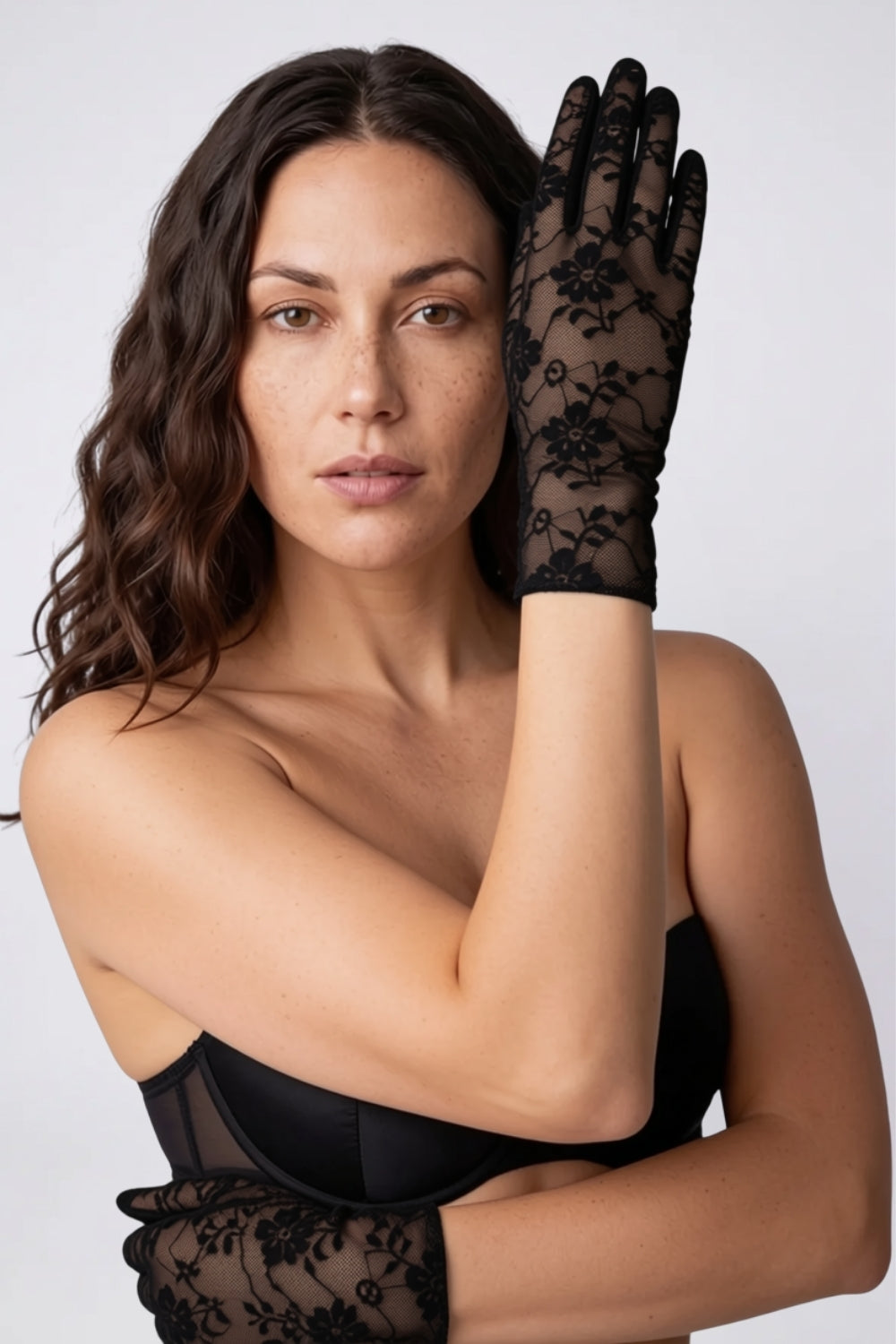 Model wearing sheer floral lace gloves in black