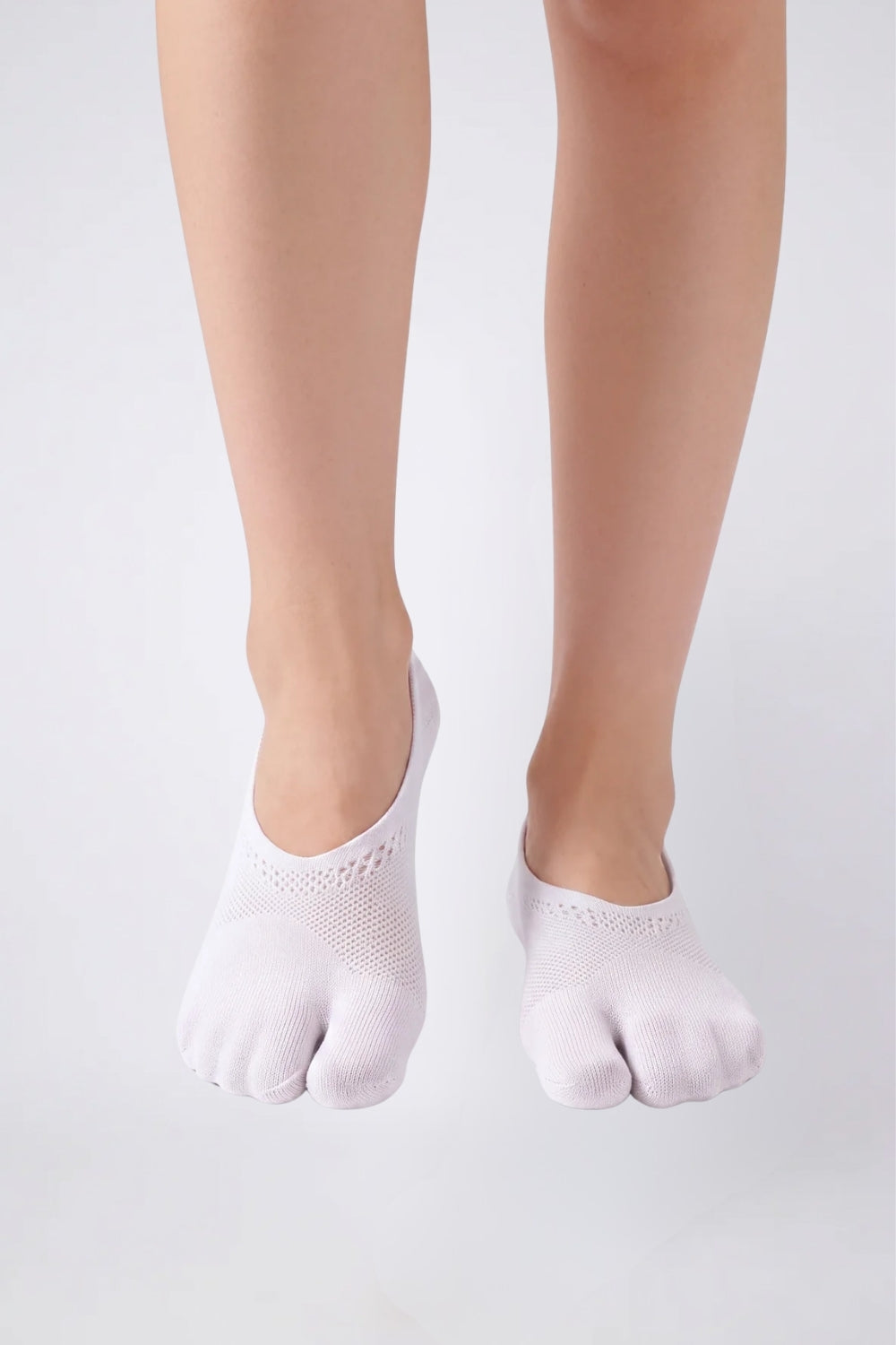 Model wearing split-toe no-show stockings in white