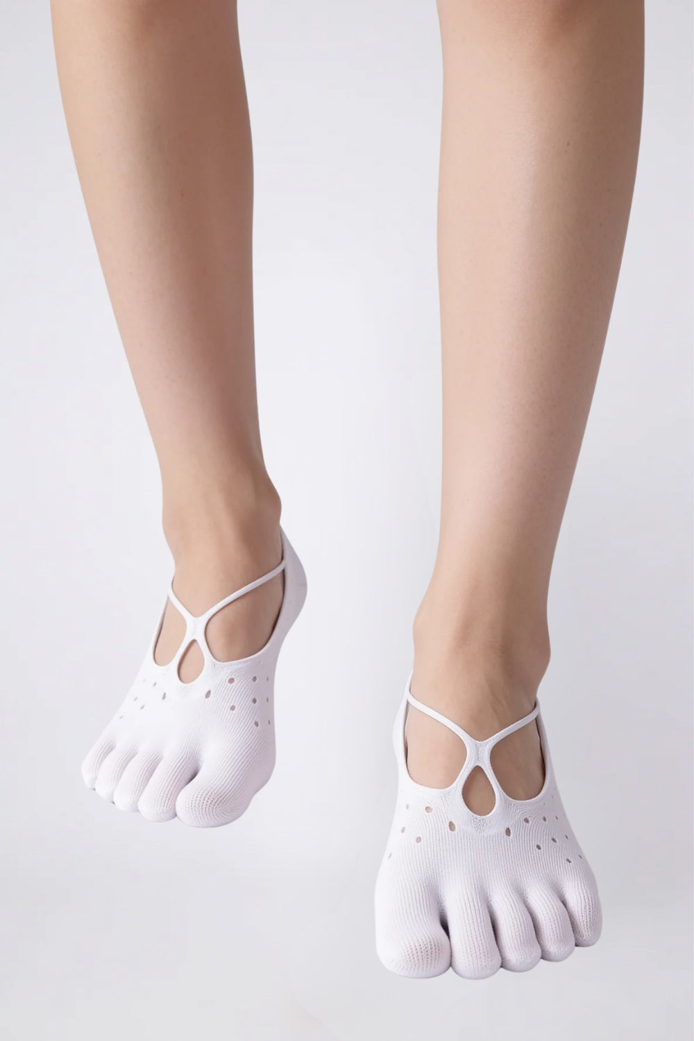 Model wearing strappy five-toe no-show stockings in white