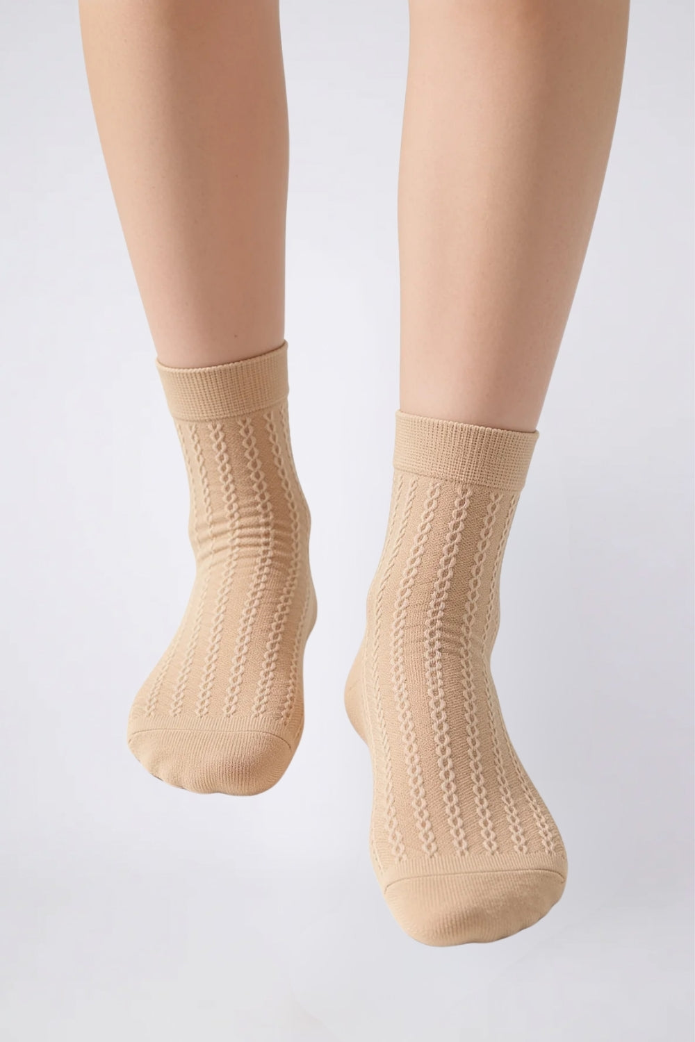Model wearing textured ultra-thin ankle stockings in nude