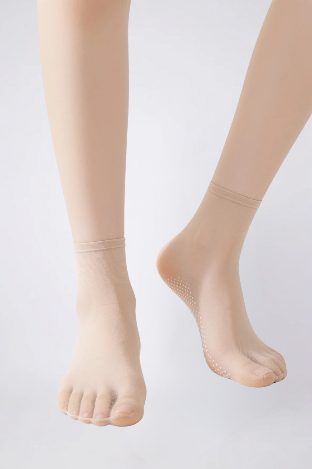 Model wearing ultra-thin sheer grip sole stockings in nude