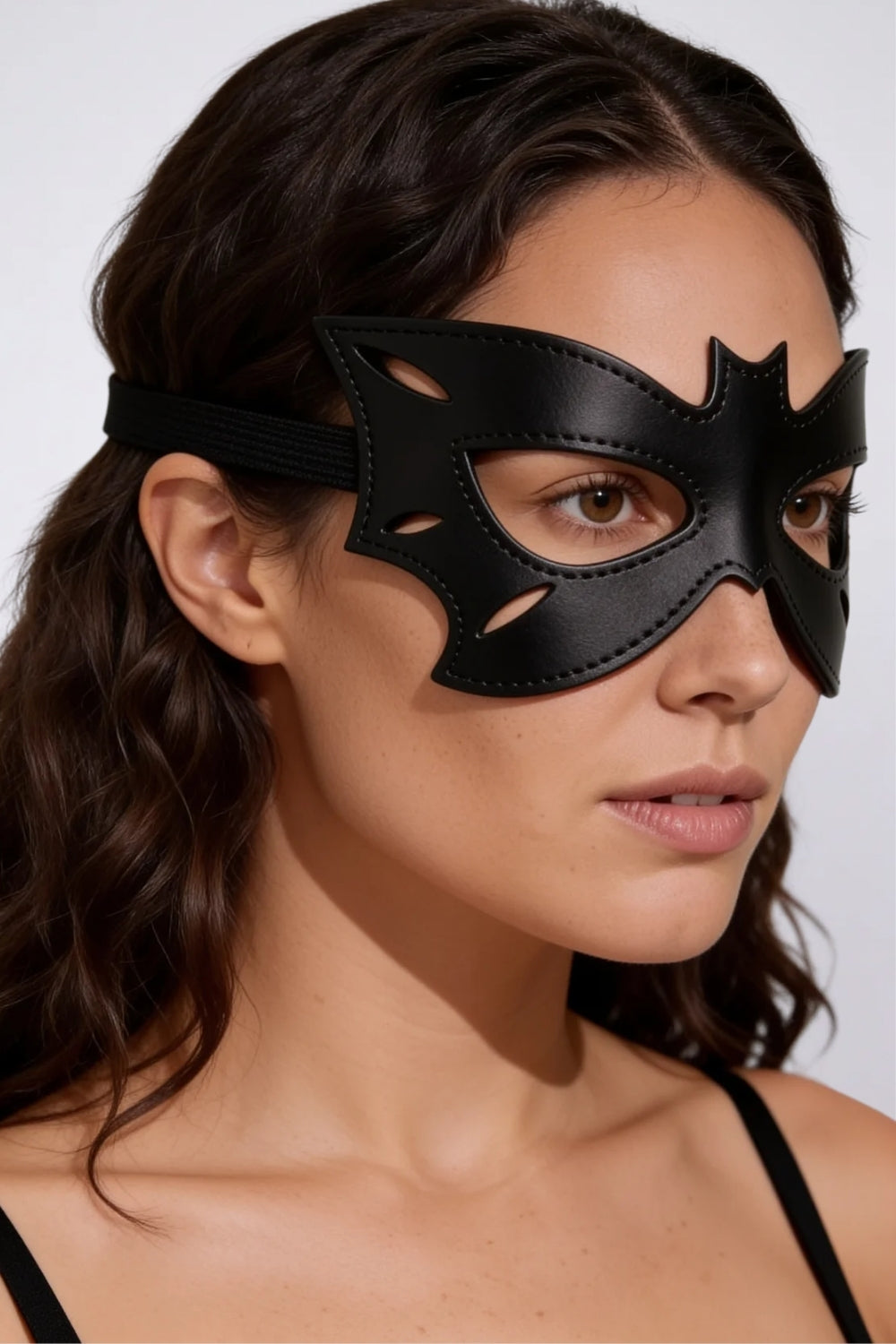 Model wearing bat wing grain finish eye mask in black, alternate view
