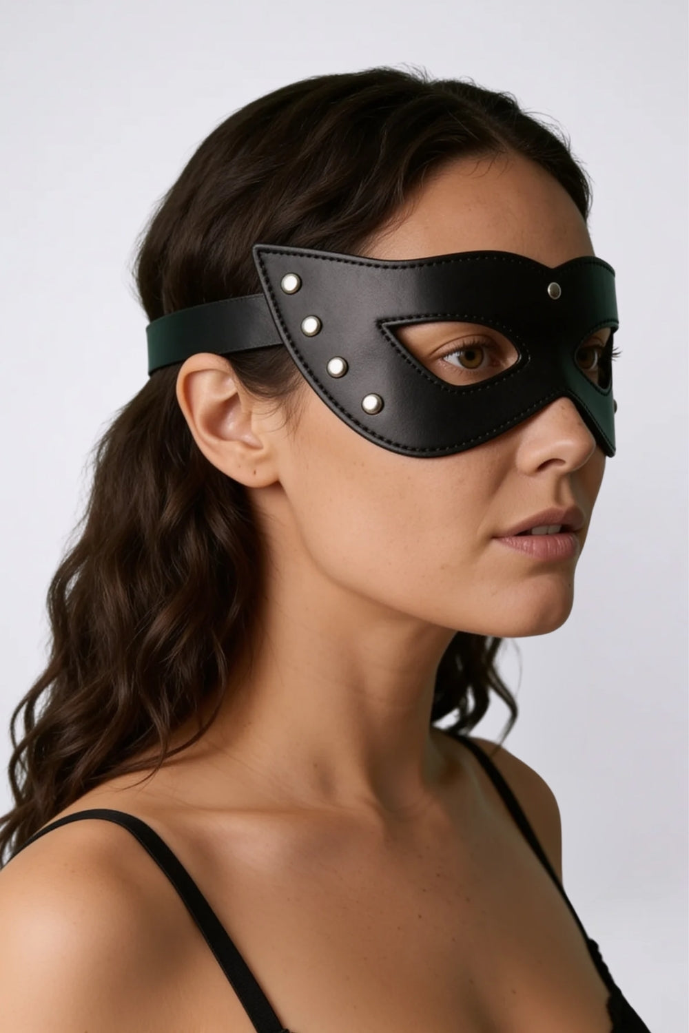 Model wearing rivet trim grain finish eye mask in black, alternate view