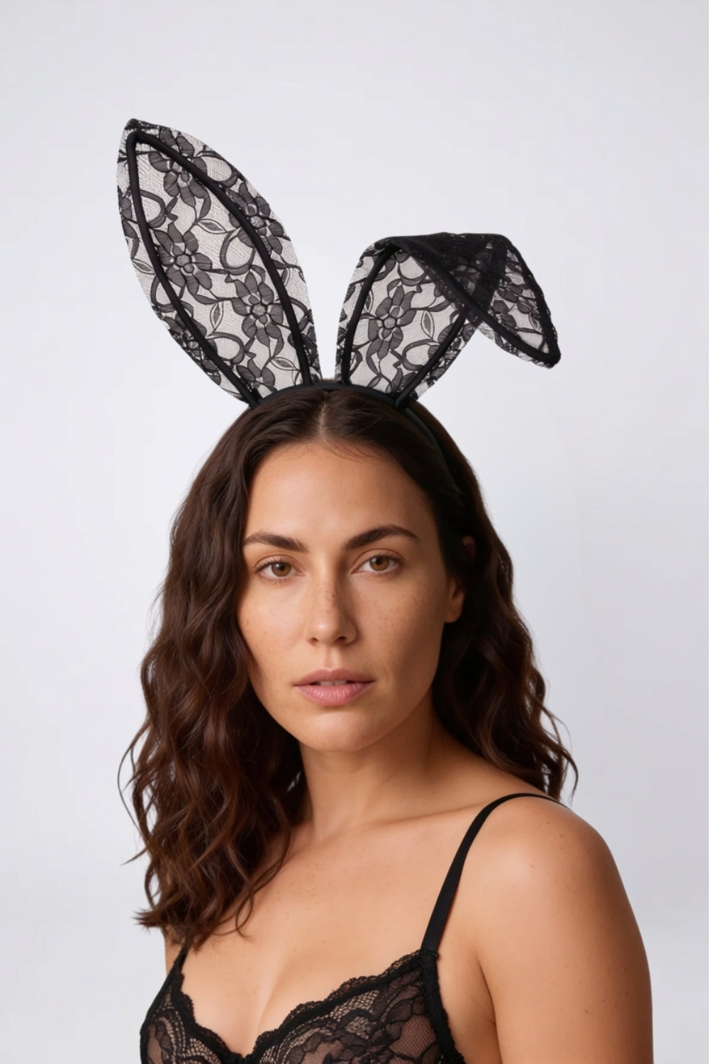 Model wearing sheer floral lace bunny ears headwear in black, alternate view