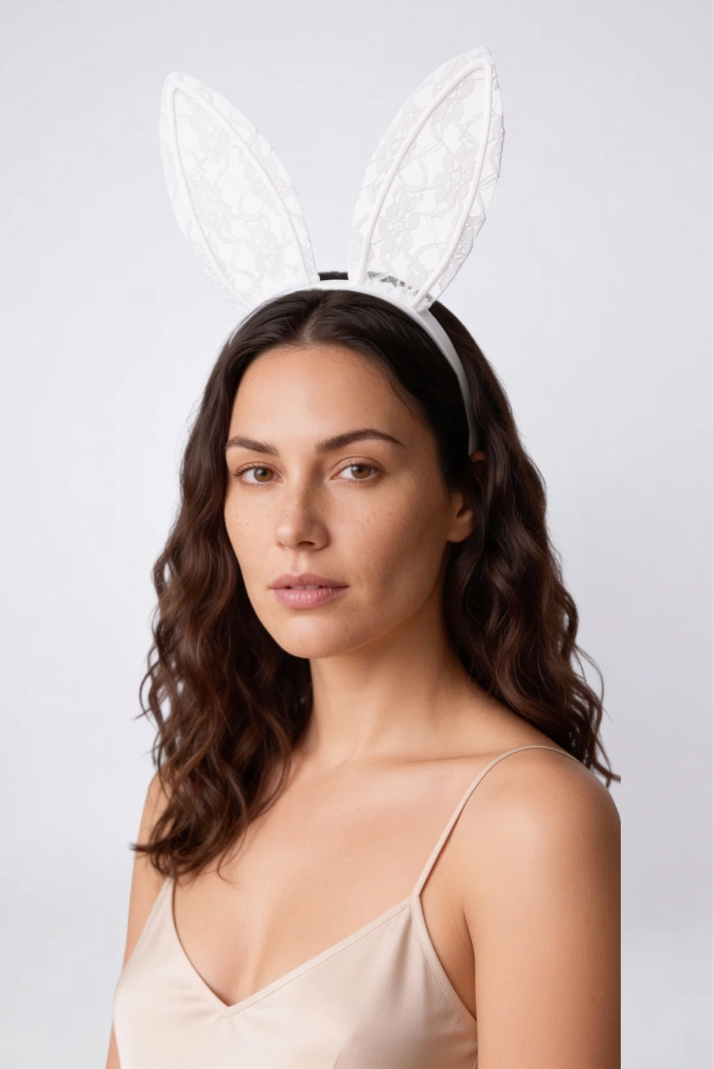Model wearing sheer floral lace bunny ears headwear in white