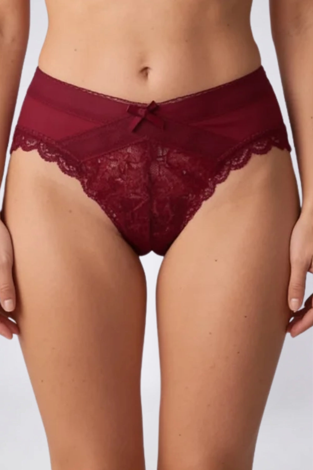 Model wearing floral lace crossover brief in red