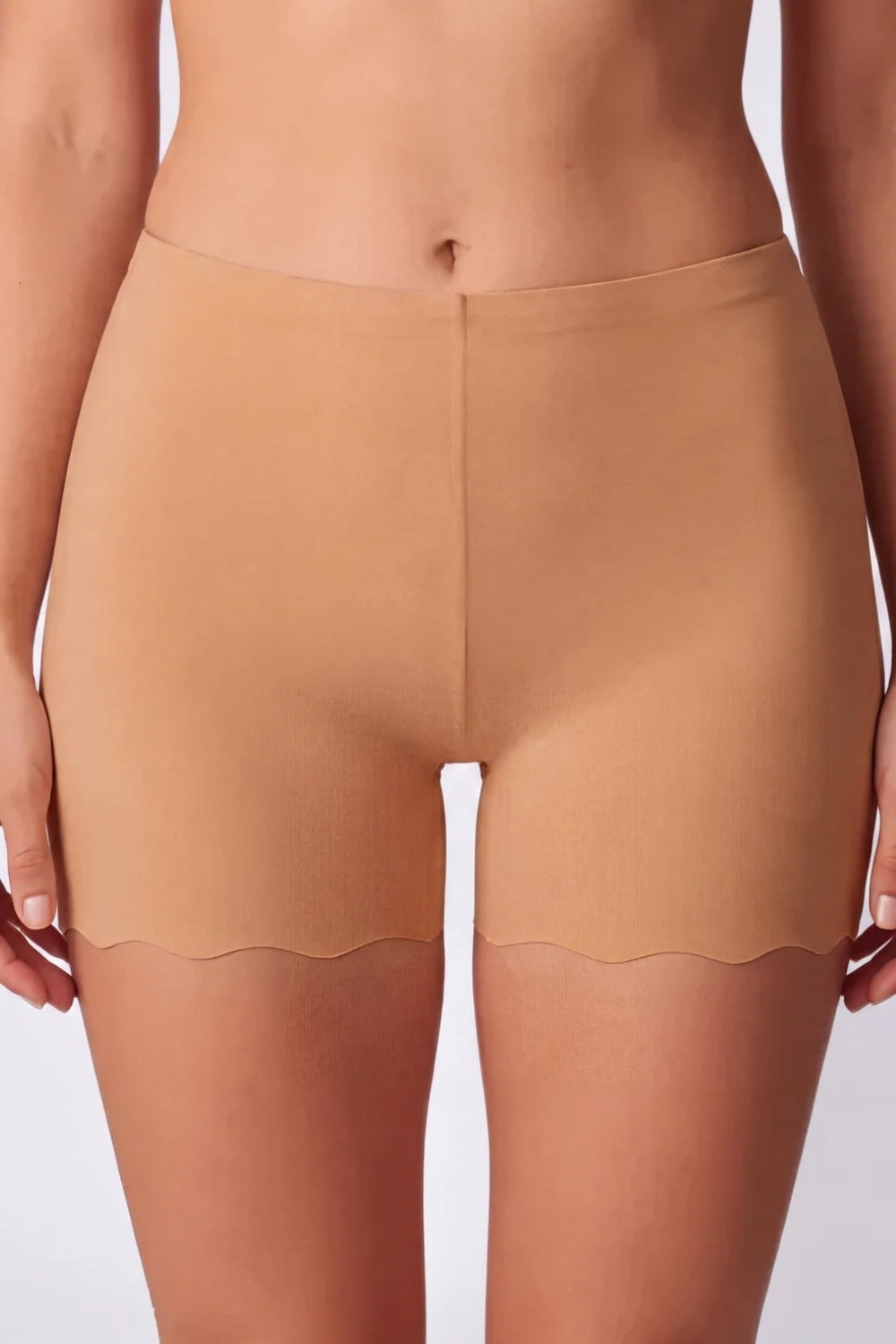 Model wearing laser-cut seamless boyshort in almond