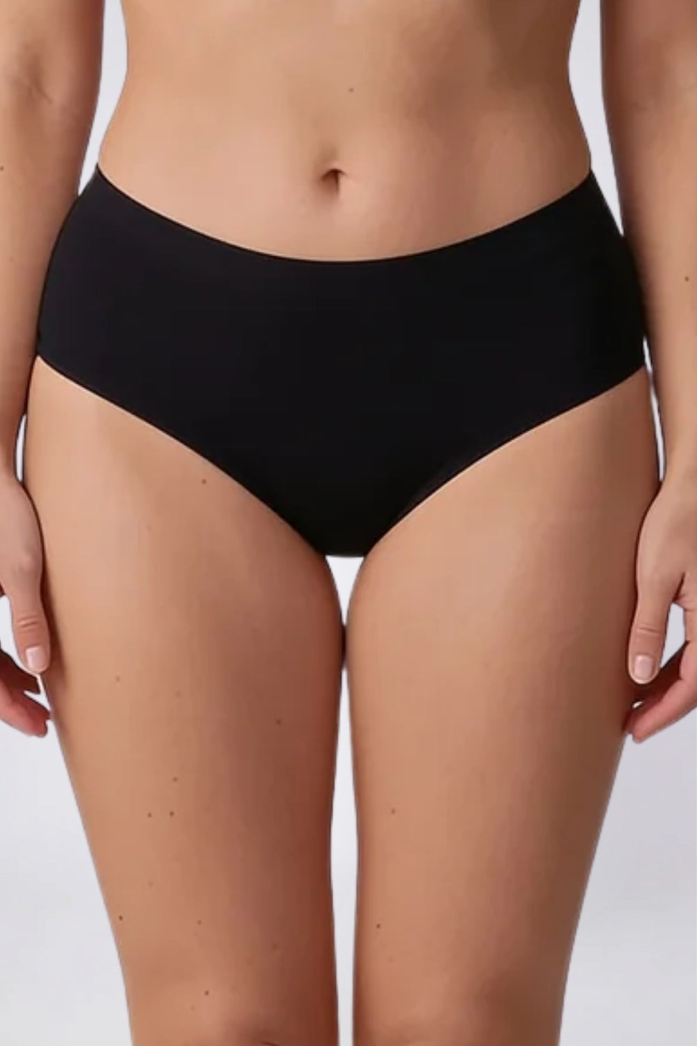 Model wearing laser-cut seamless brief in onyx