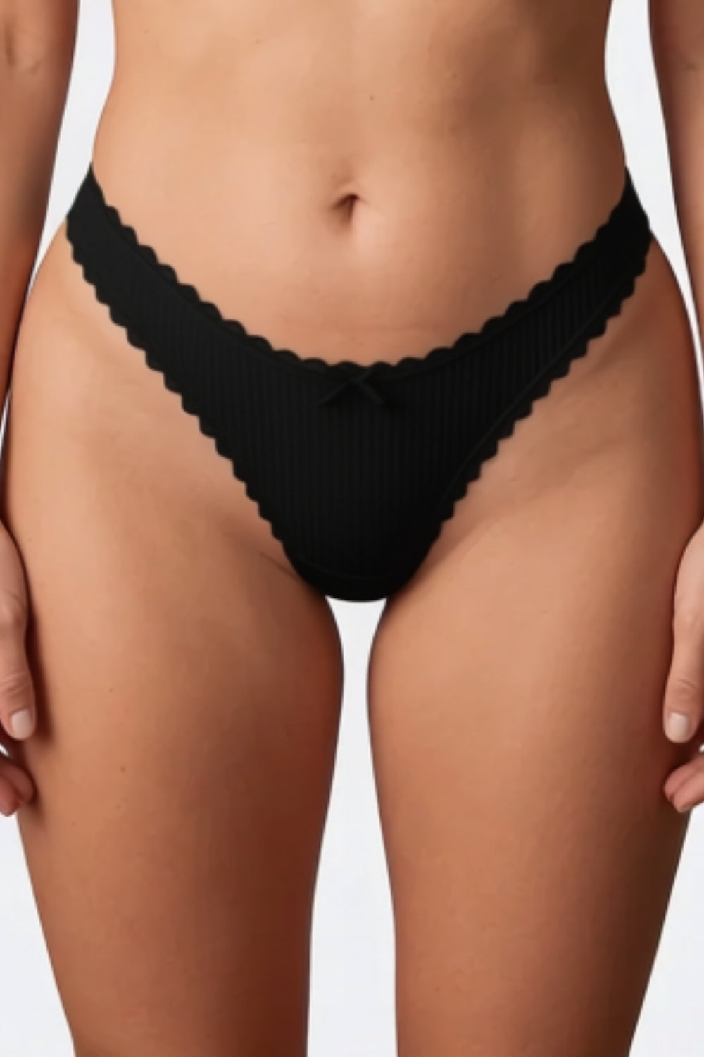Model wearing ribbed lace trim thong in black