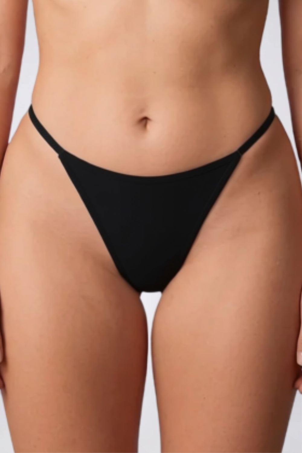 Model wearing ribbed minimalist thong in black