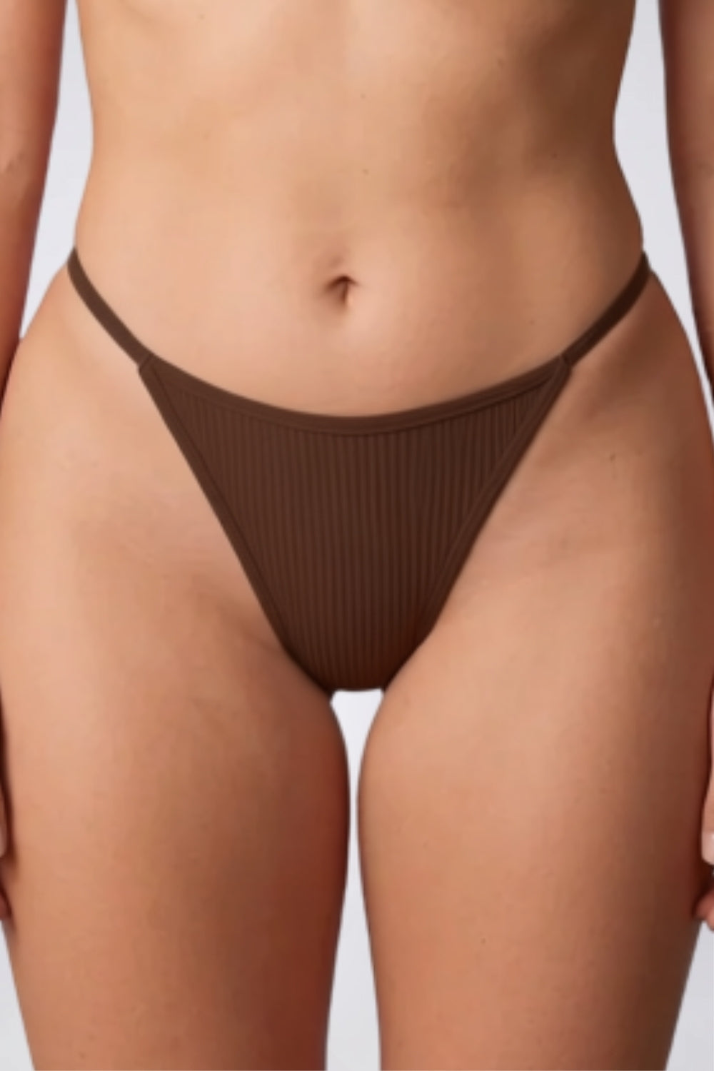 Model wearing ribbed minimalist thong in green, alternate view