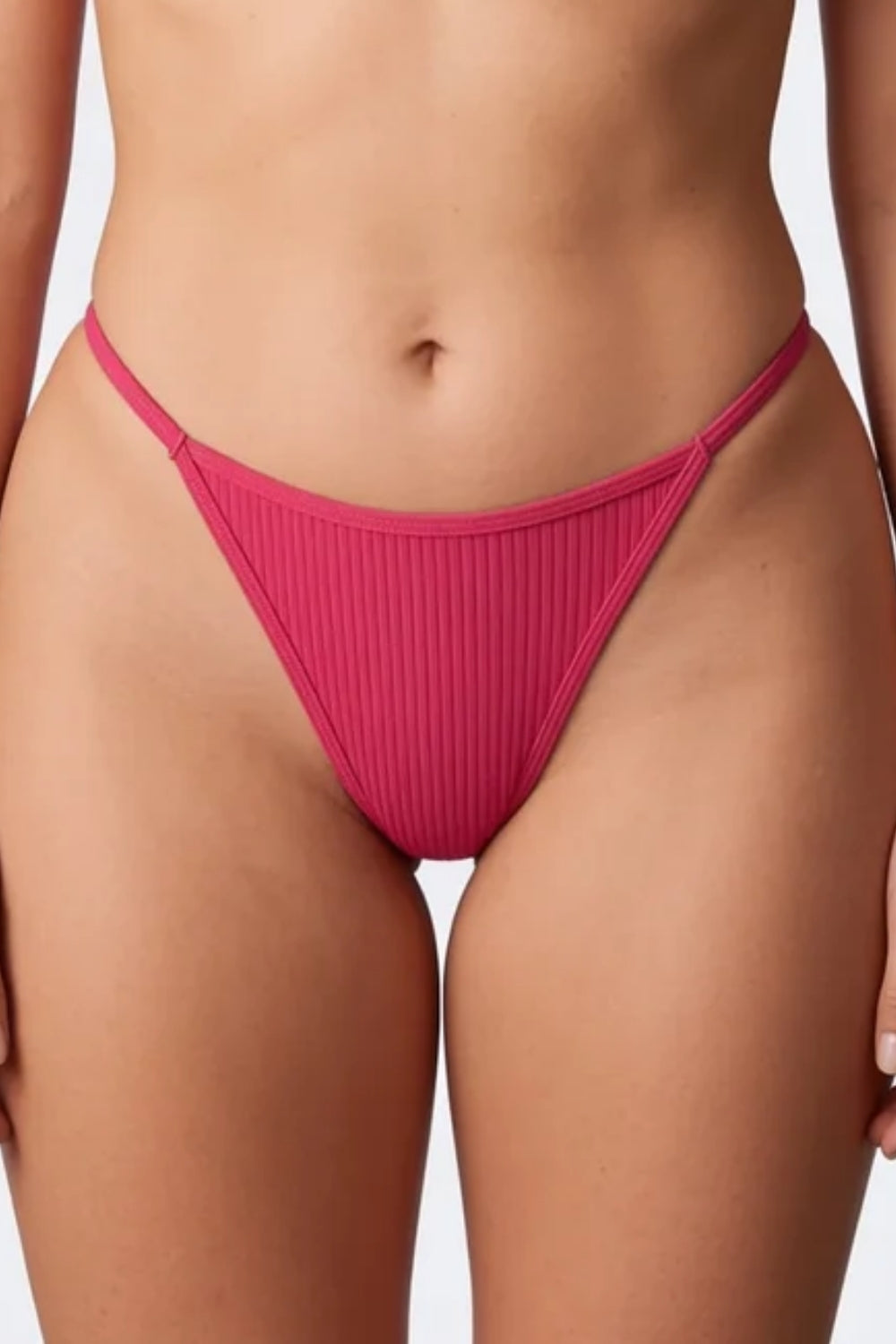 Model wearing ribbed minimalist thong in pink