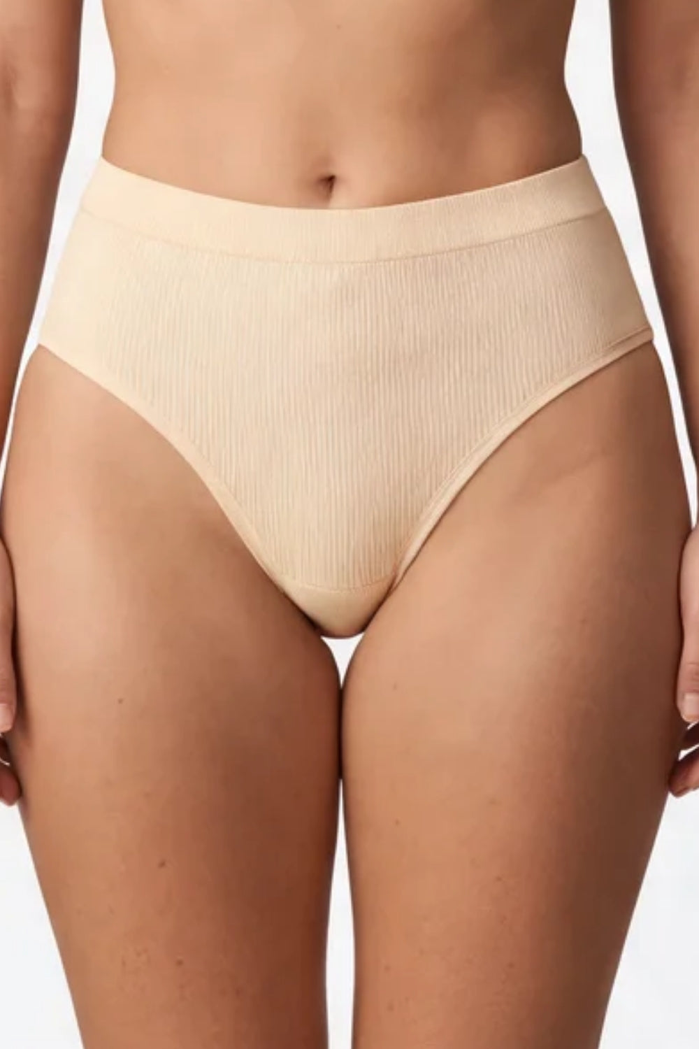 Model wearing ribbed seamless brief in oat