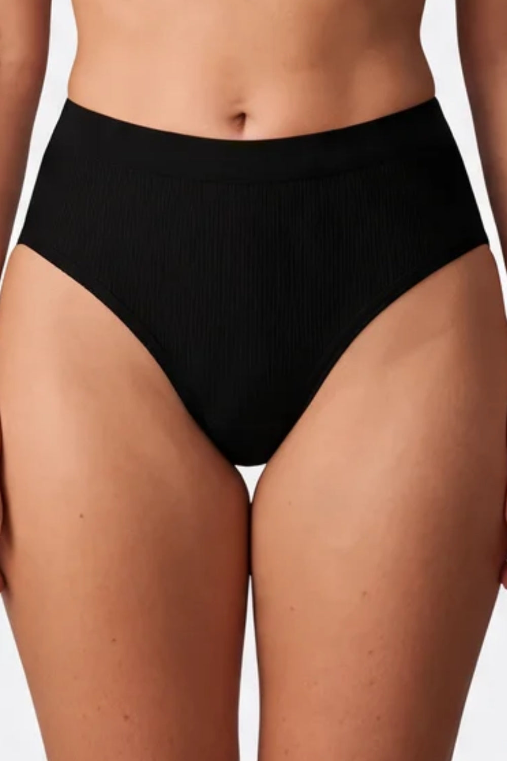 Model wearing ribbed seamless brief in onyx