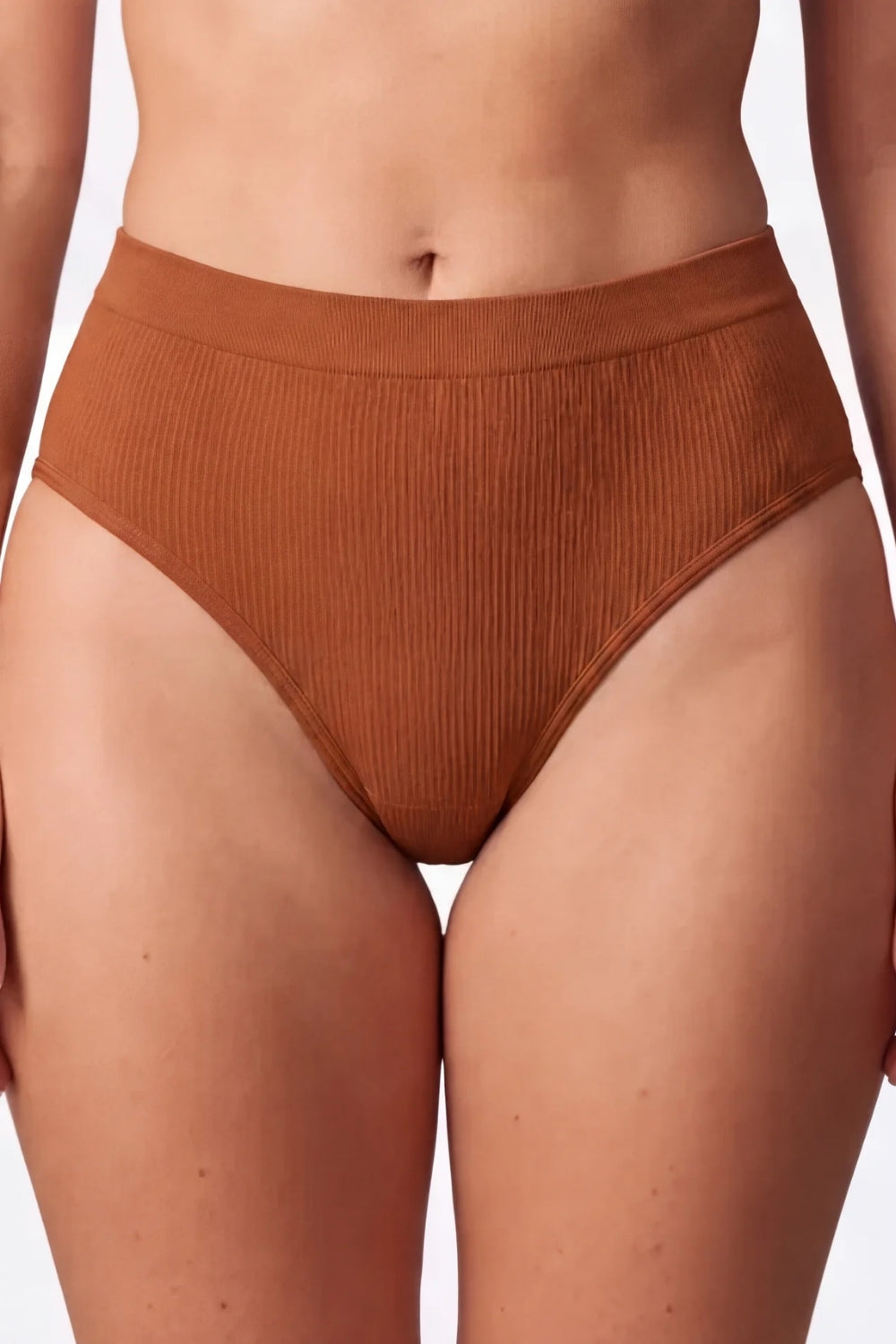 Model wearing ribbed seamless brief in sienna