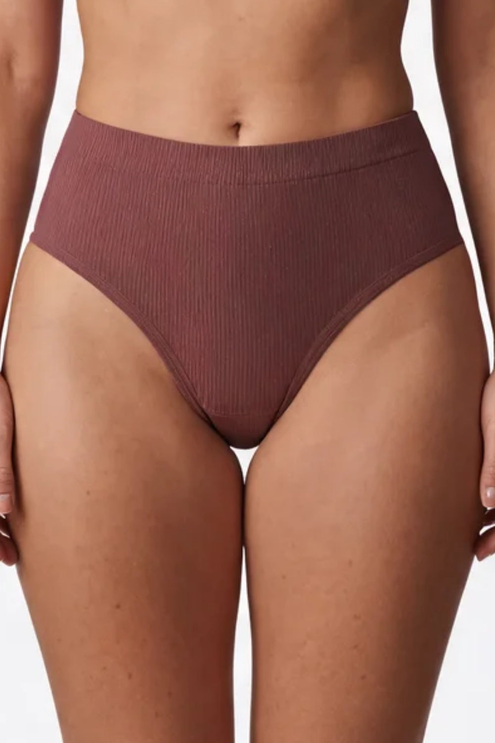 Model wearing ribbed seamless brief in umber