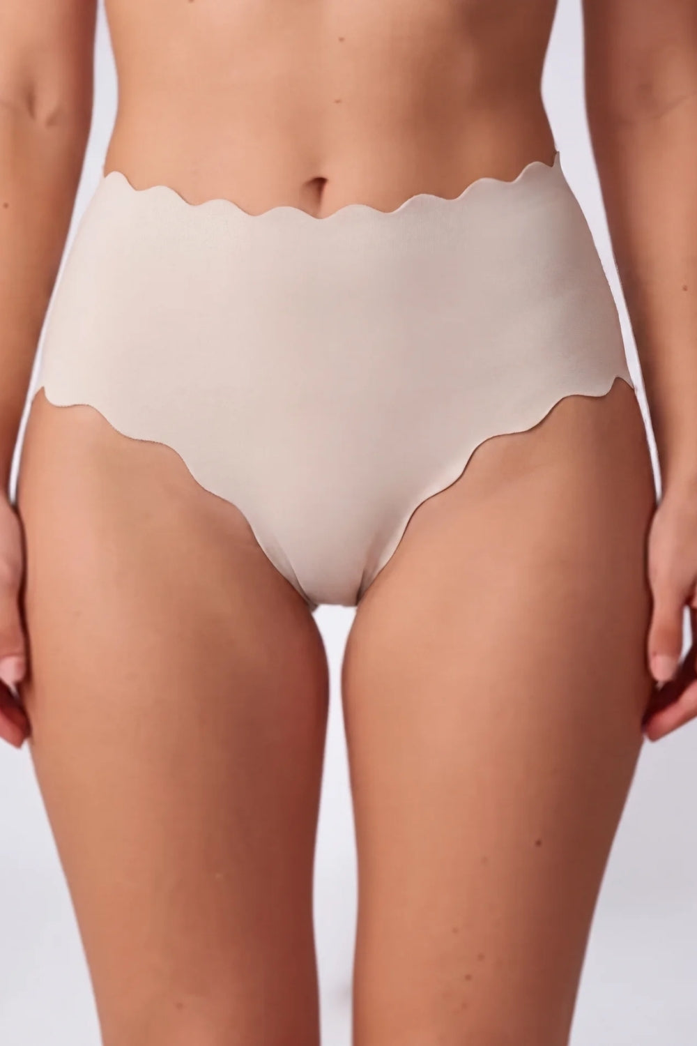 Model wearing scalloped seamless brief in oat