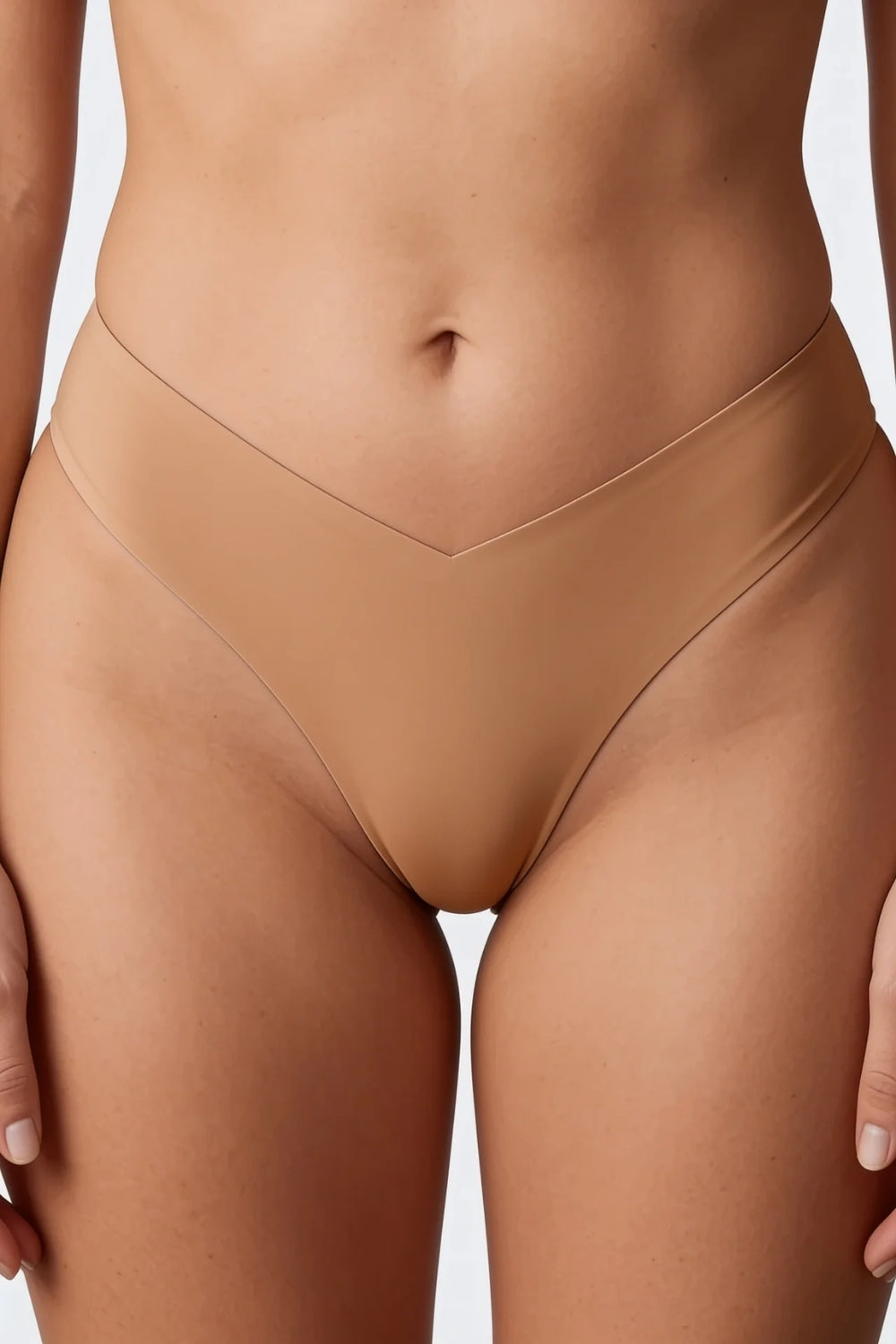 Model wearing silky seamless v waist brief in sand