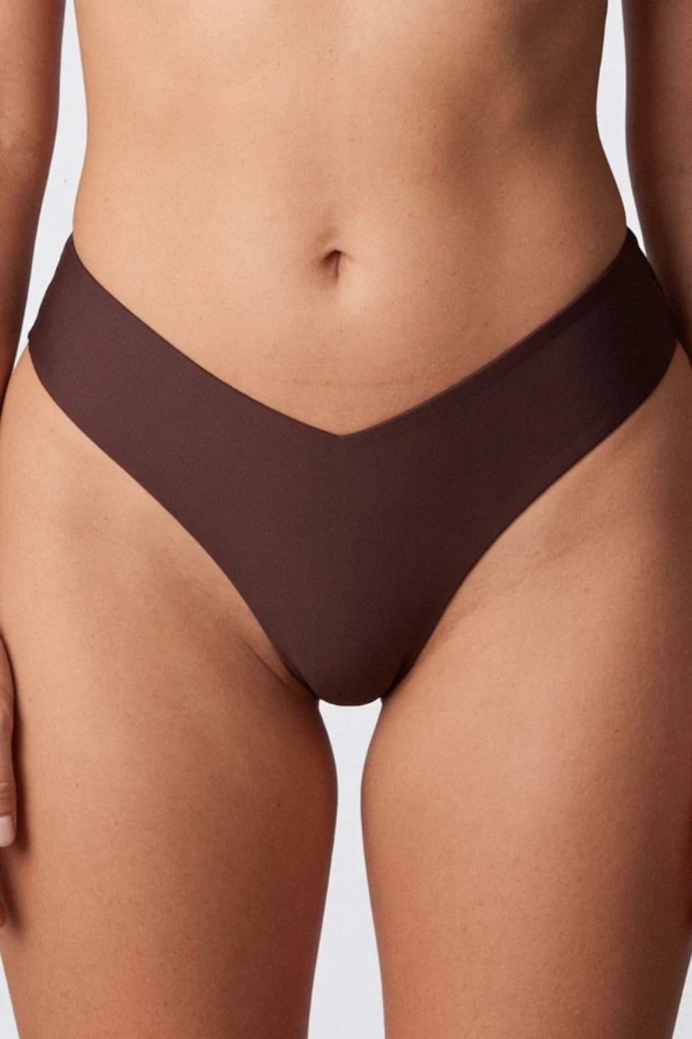 Model wearing silky seamless v waist brief in sienna