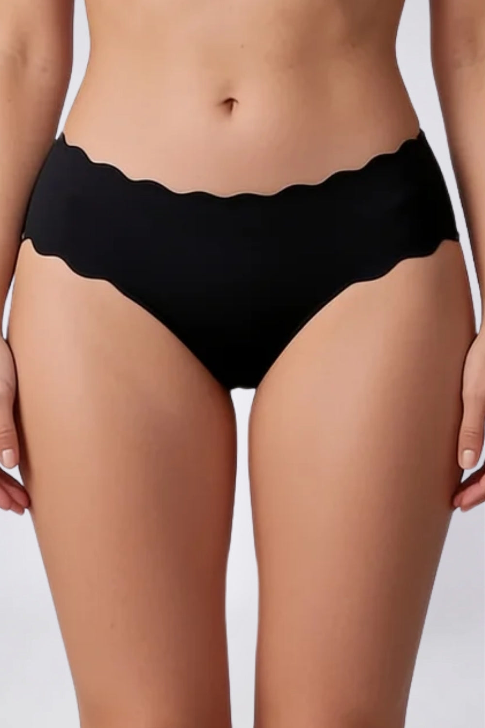 Model wearing wavy edge seamless brief in onyx