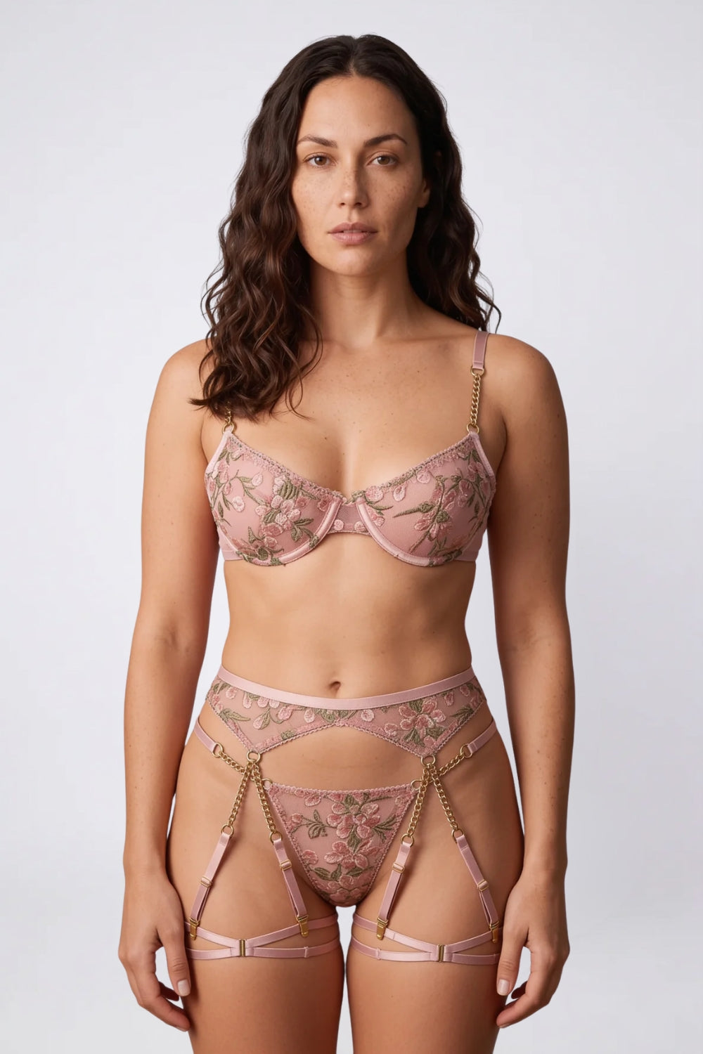 Model wearing chain accent floral embroidery three-piece lingerie set in pink
