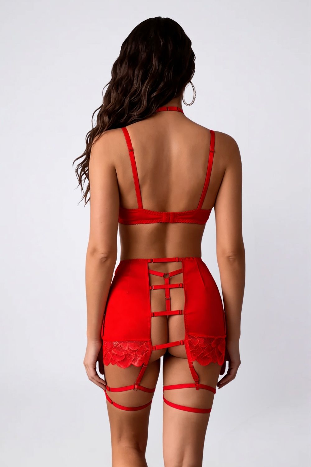 Model wearing satin lace garter three-piece lingerie set in red, alternate view