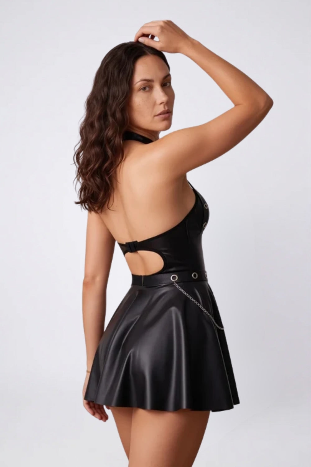 Model wearing ring detail halter mini dress in black, alternate view