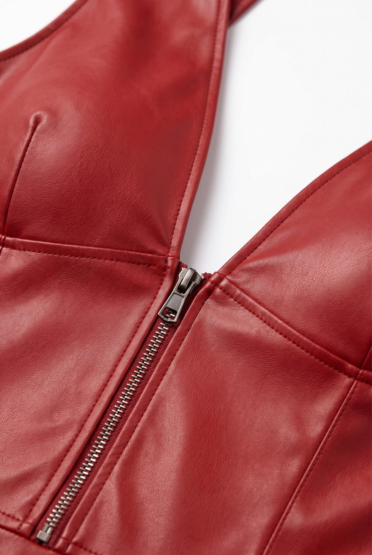 Close-up of the plunge neckline and zip of the grain finish a-line dress in red