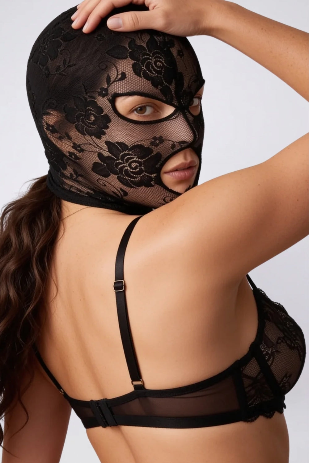 Model wearing floral lace cutout head stocking in black, alternate view