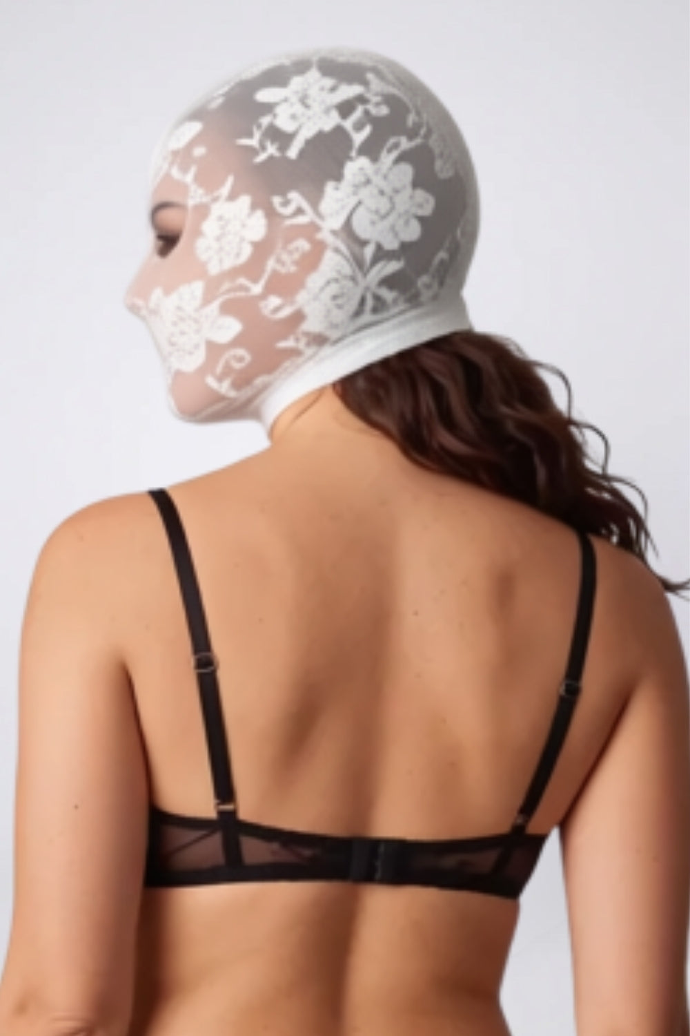 Model wearing floral lace cutout head stocking in white, back view