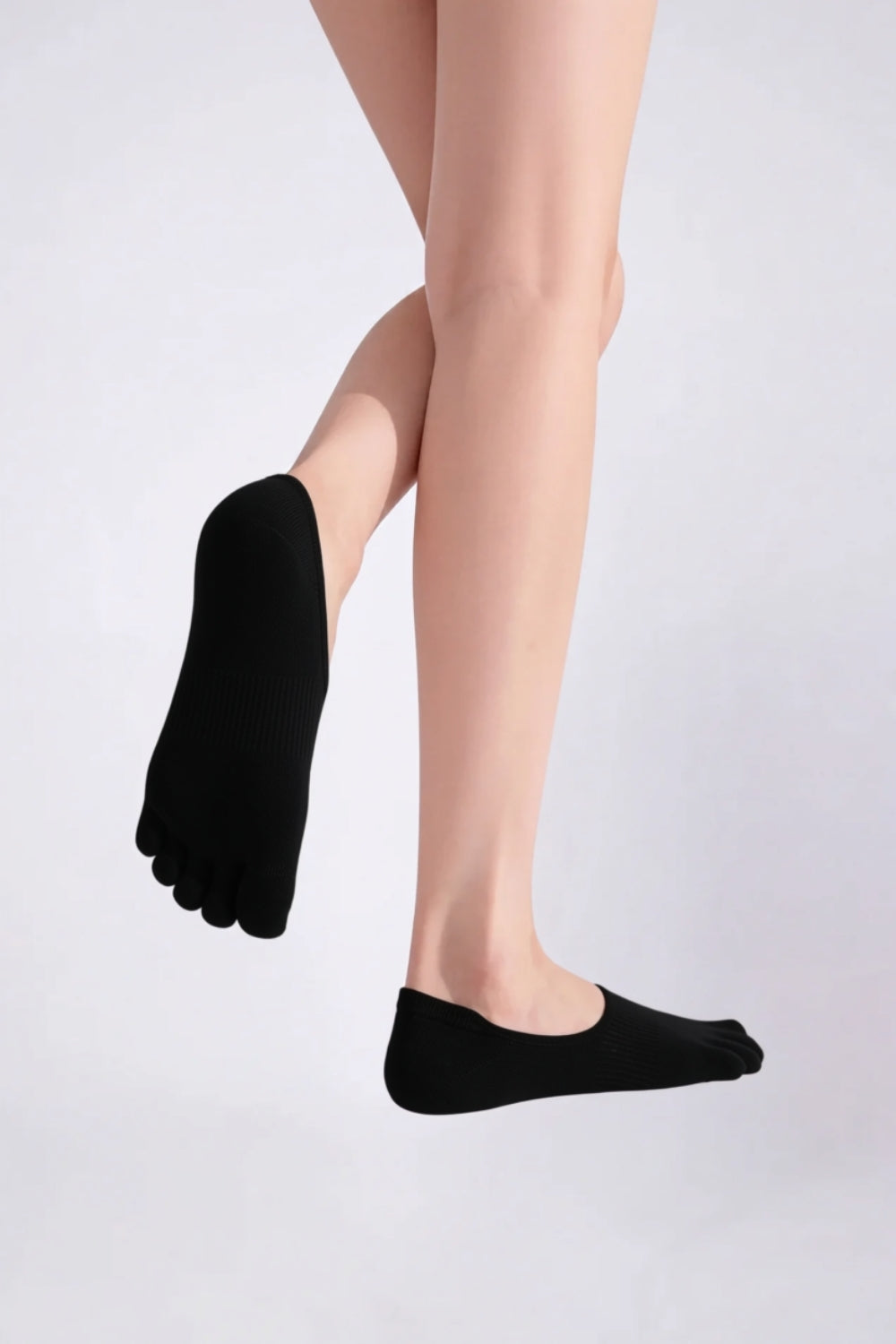Model wearing lyocell five-toe no-show stockings in black, alternate view
