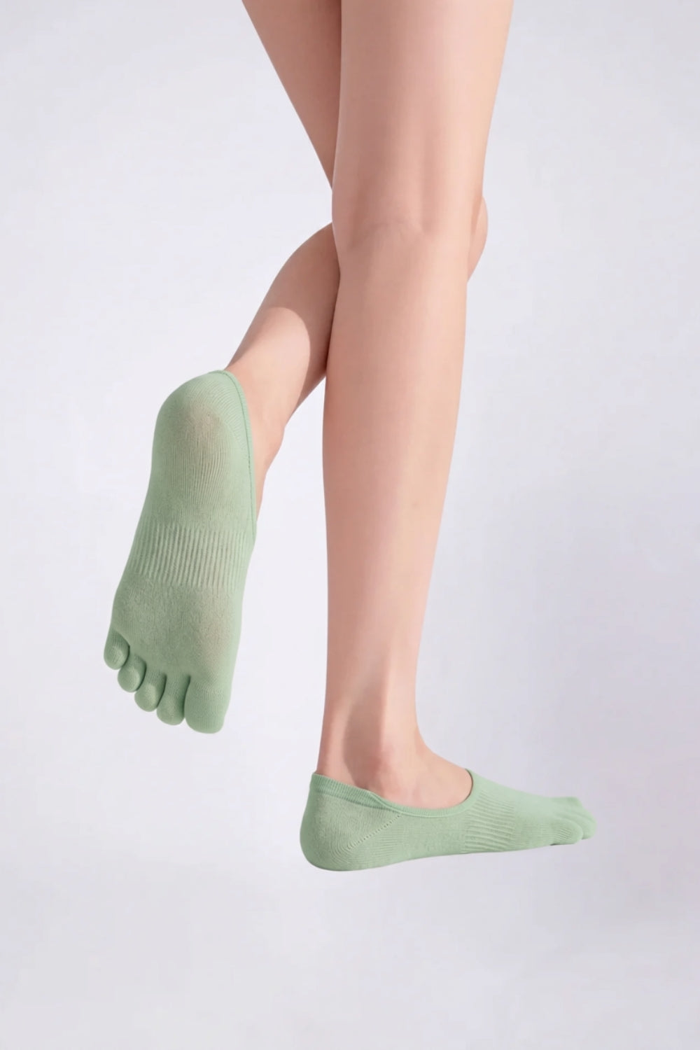 Model wearing lyocell five-toe no-show stockings in green, alternate view