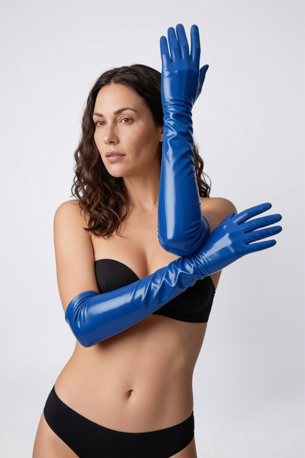 Model wearing metallic glossy mid-length gloves in blue, alternate view