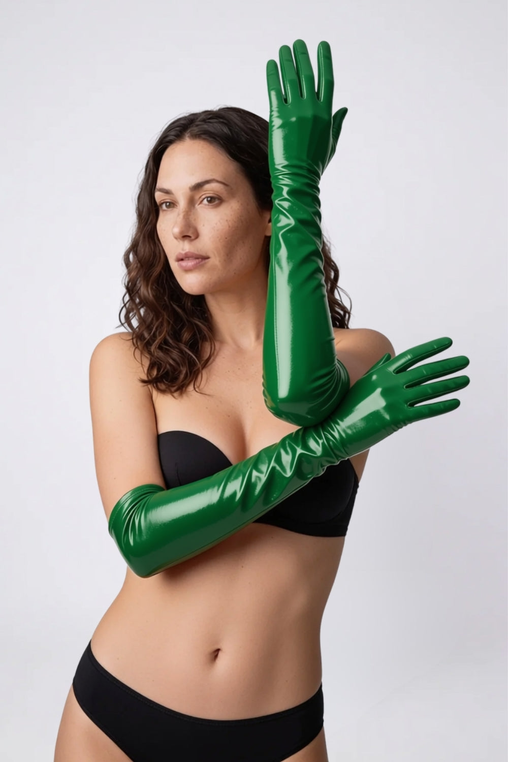 Model wearing metallic glossy mid-length gloves in green, alternate view