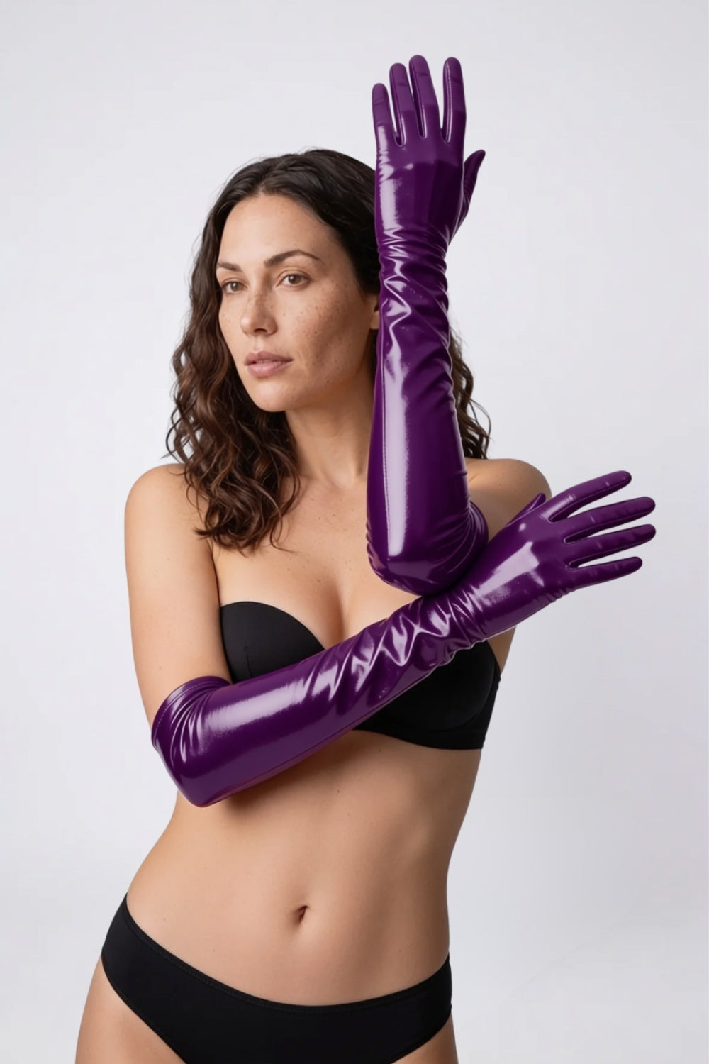 Model wearing metallic glossy mid-length gloves in purple, alternate view