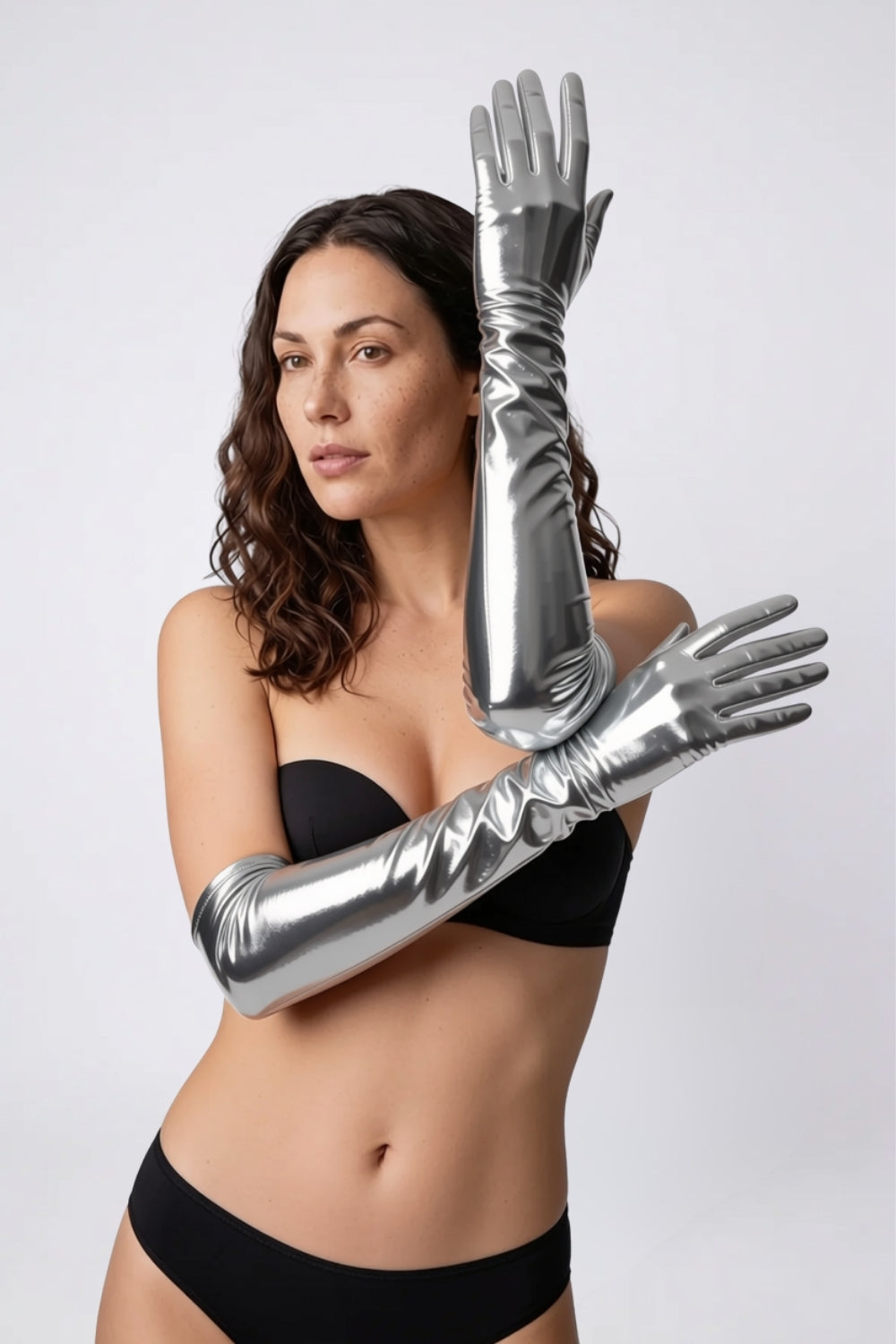 Model wearing metallic glossy mid-length gloves in silver, alternate view