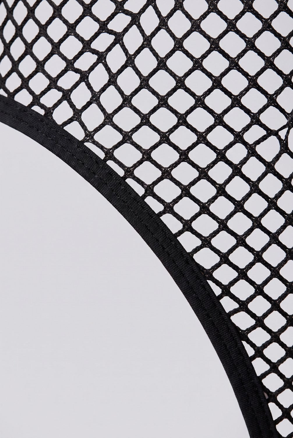 Close-up of the fishnet mesh and finished edge of the midnight mesh allure bodystocking in black