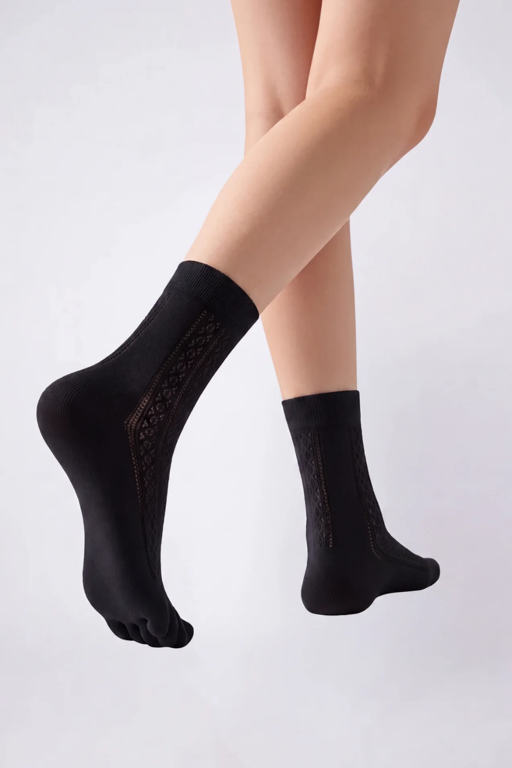 Model wearing openwork five-toe ankle stockings in black, alternate view