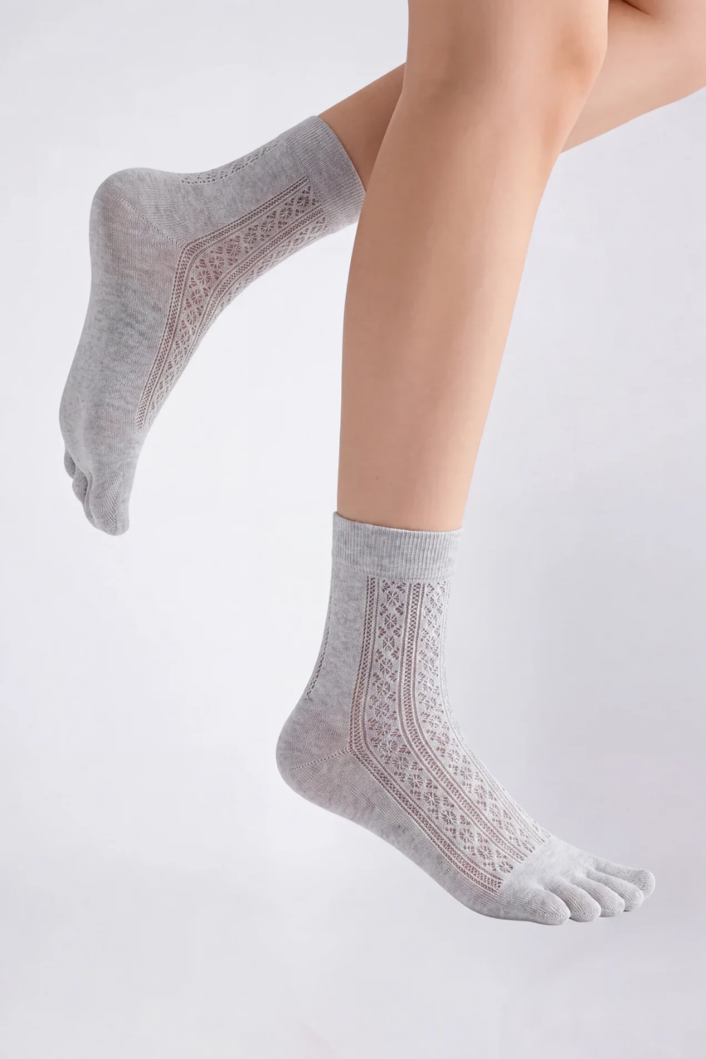 Model wearing openwork five-toe ankle stockings in grey, alternate view