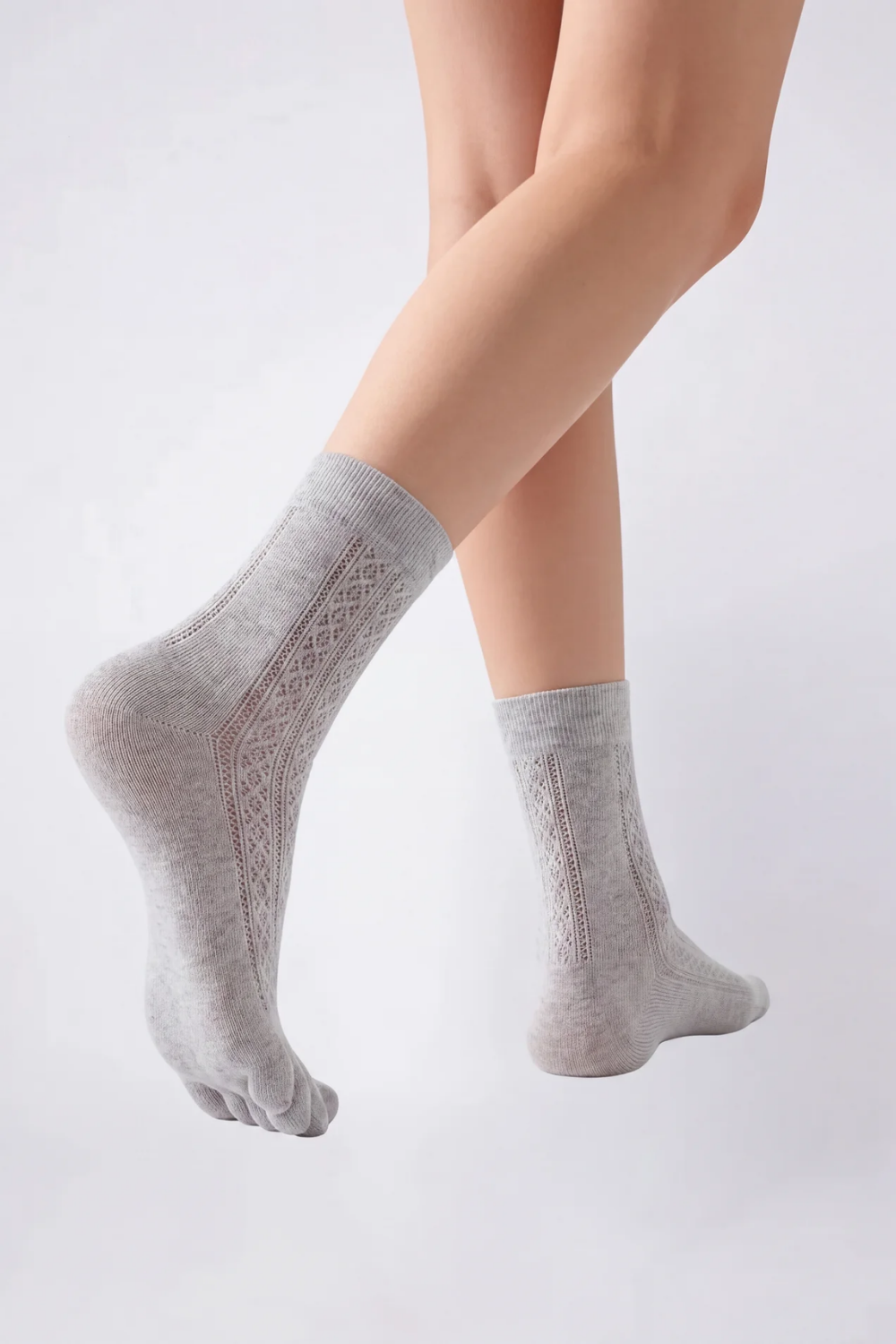 Model wearing openwork five-toe ankle stockings in grey, alternate view