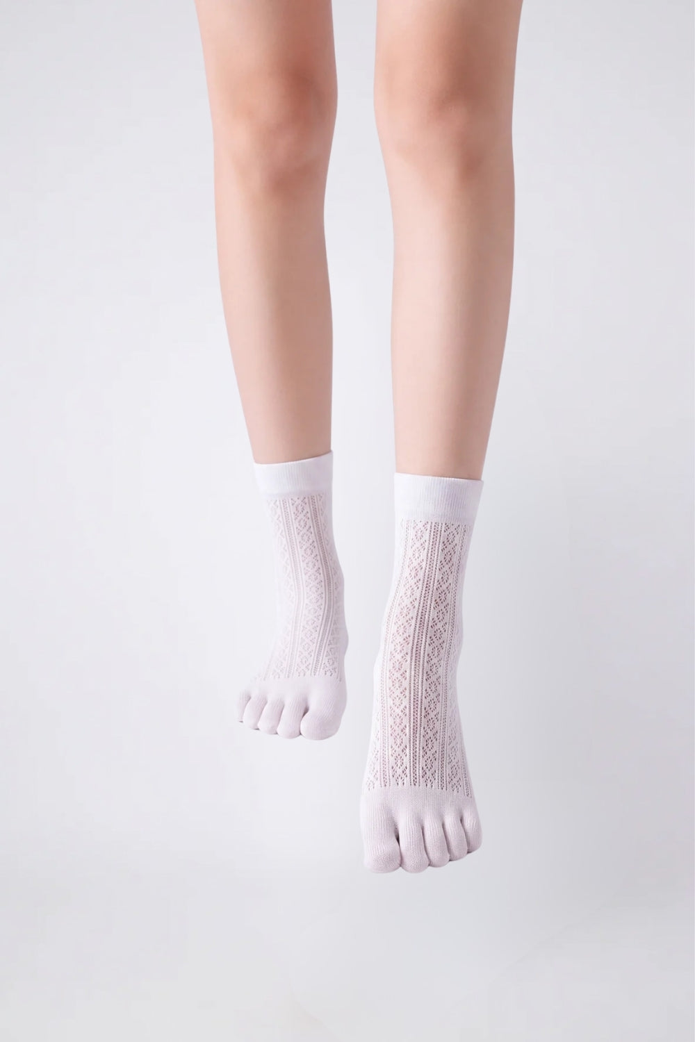 Model wearing openwork five-toe ankle stockings in white