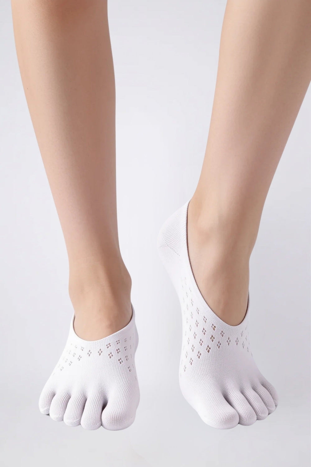 Model wearing openwork five-toe no-show stockings in white