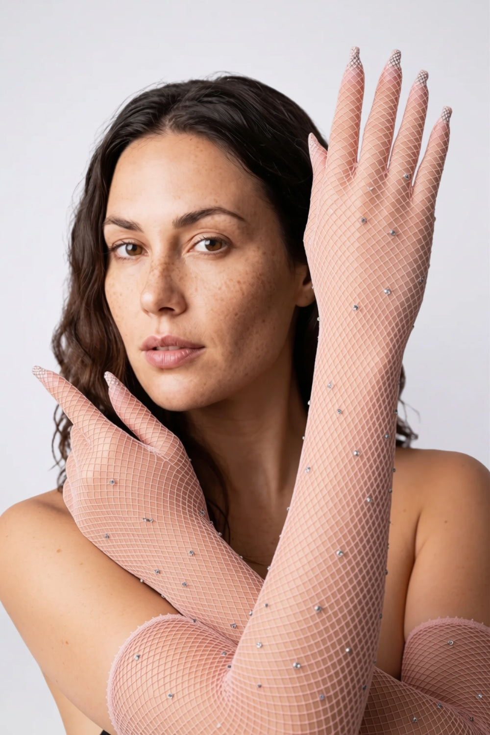 Model wearing rhinestone fishnet gloves in light pink, alternate view