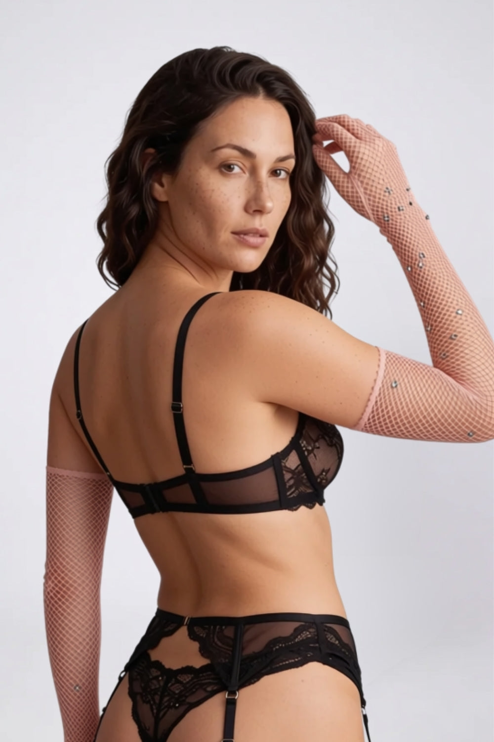 Model wearing rhinestone fishnet gloves in light pink, alternate view