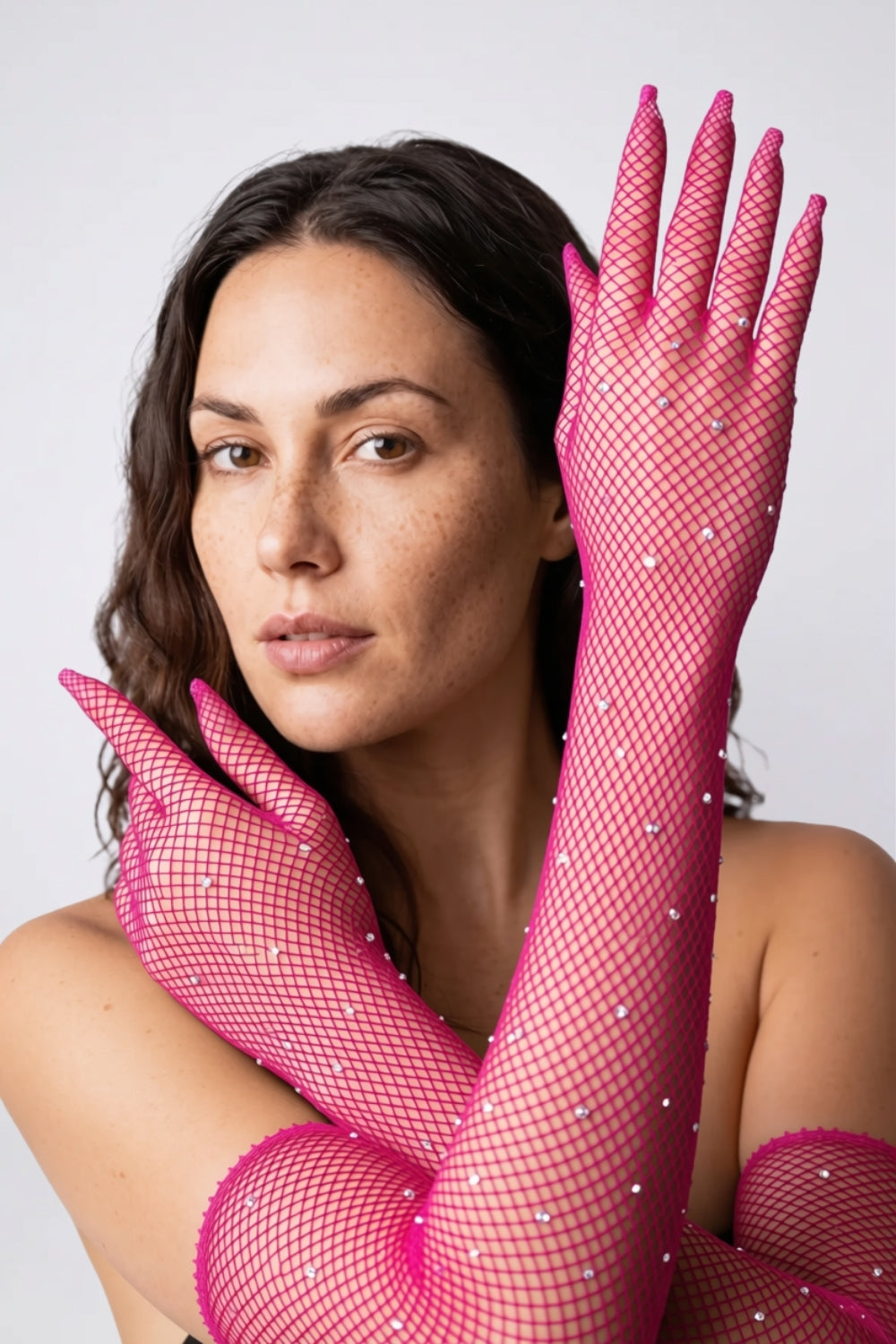 Model wearing rhinestone fishnet gloves in pink, alternate view