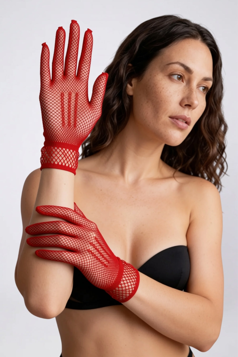 Model wearing sheer fishnet wrist gloves in red, alternate view