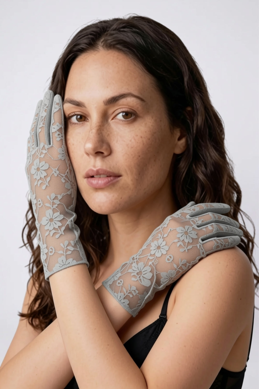 Model wearing sheer floral lace gloves in grey, alternate view