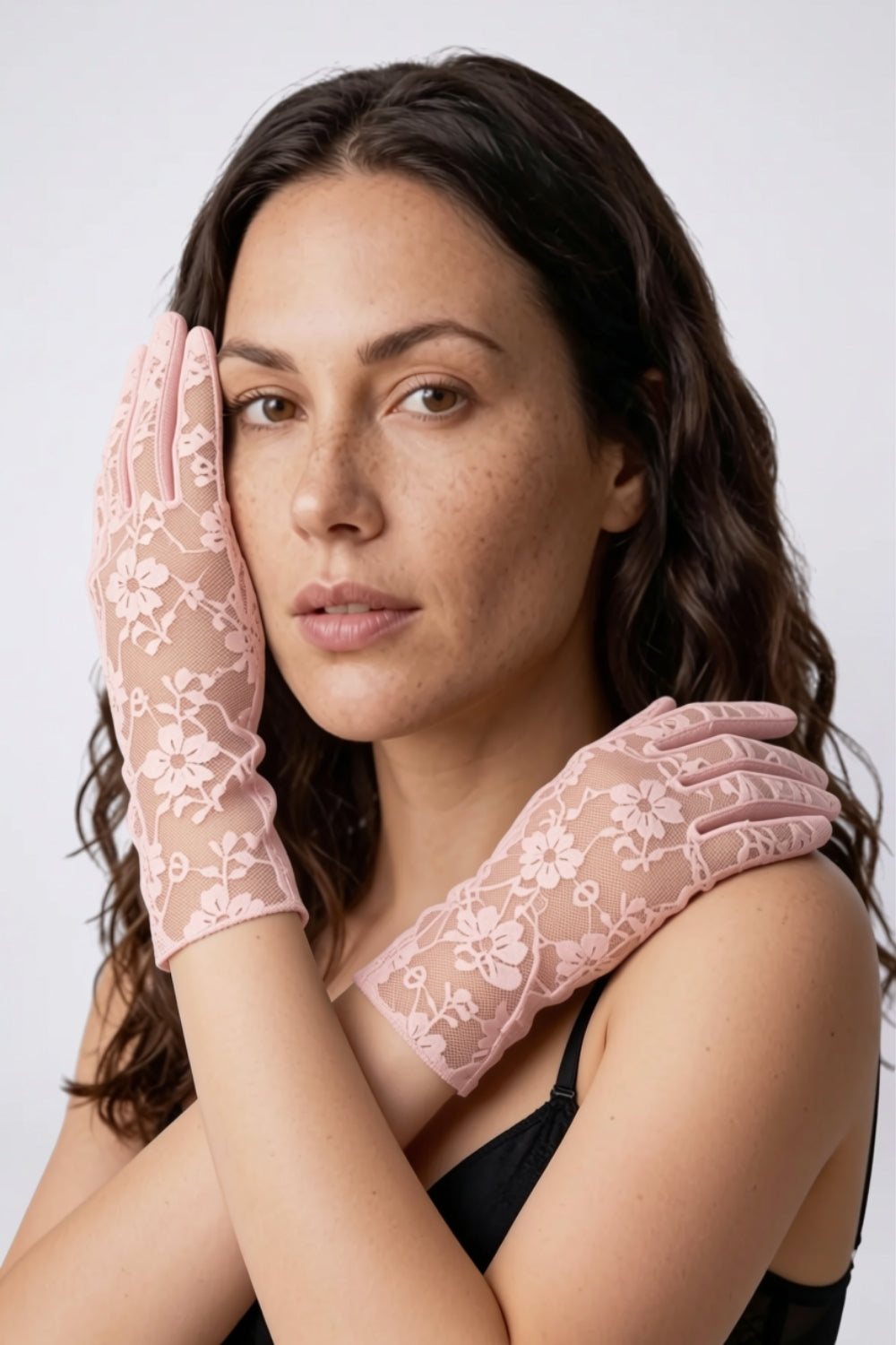 Model wearing sheer floral lace gloves in pink, alternate view