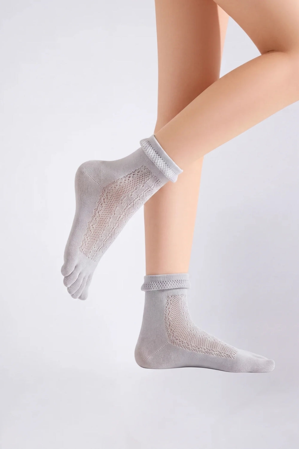 Model wearing sheer lace five-toe stockings in grey, alternate view